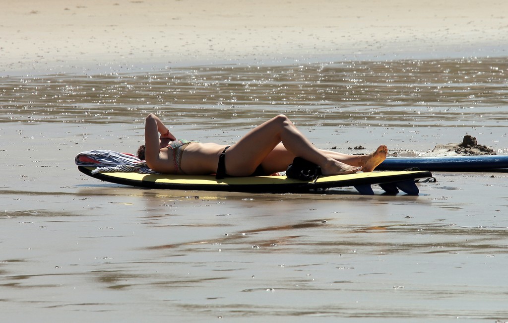 Sexy woman sun tanning on a beach Great Ocean Road Australia