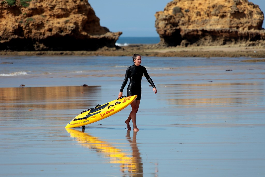Surf Life Saving Australia girl with paddle board beach