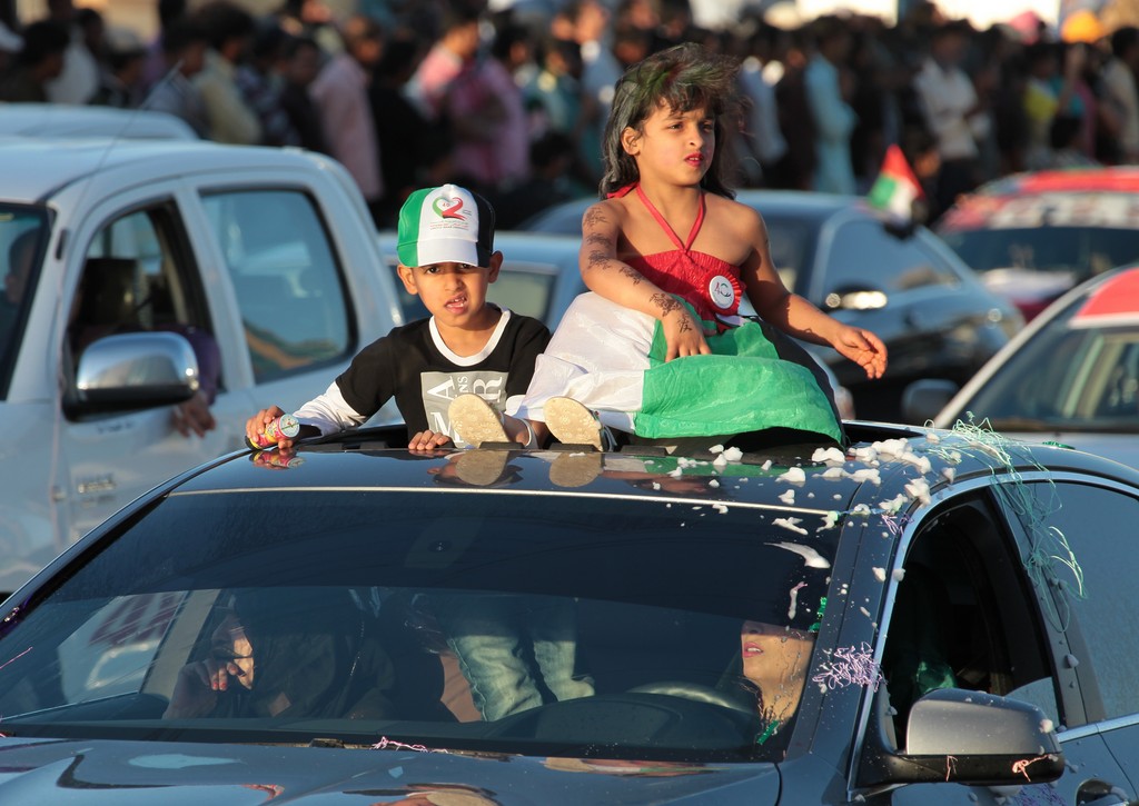 girl and boy top of the car abu dhabi national day 40th anniversary UAE fete nationale 