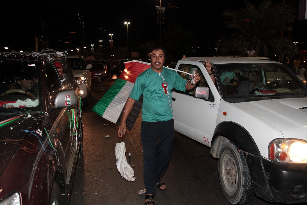 walk in the street uae flag man stand up proud to be emirien national day 40th anniversary