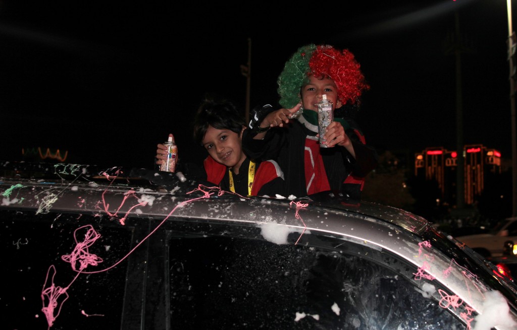 children with foam bomb top of car corniche abu dhabi 40th national day abu dhabi