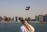 Emirati Man helicopter flag over Abu Dhabi UAE