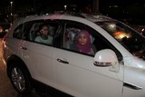 women in a car abu dhabi corniche national day 40th anniversary 