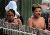 penny diver maori boys walking among tourist new zealand 