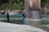 Fishing New Zealand river fish salmon girl fishing bridge green water