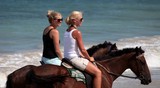 Blond girl sexy woman sunglasses horse riding Fiji